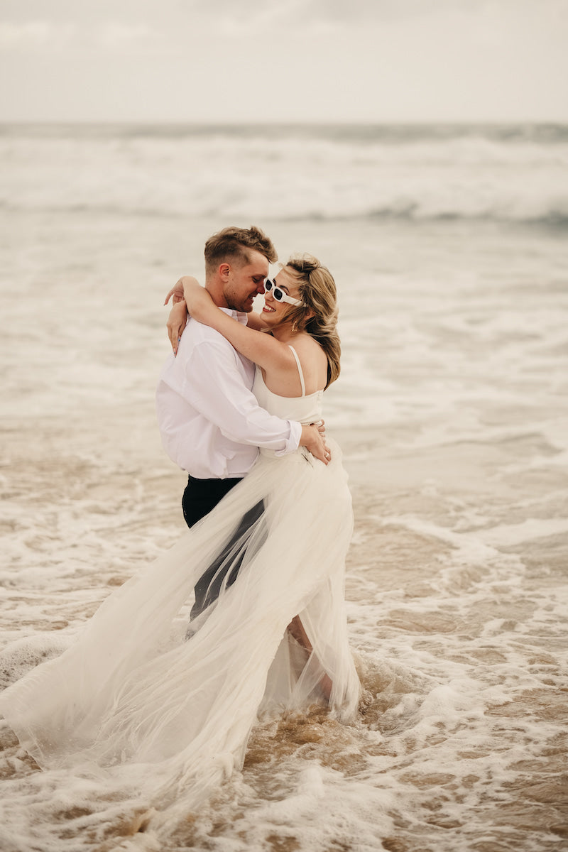 Bride and Groom in the sea at a beach wedding.