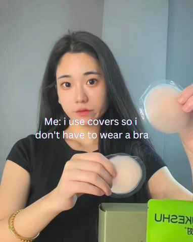 a woman holding nipple covers