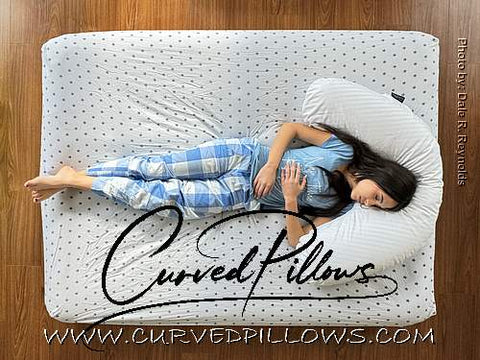 “Back Sleeper Supported by Curved Pillows: Relieving Lower Back Pain”