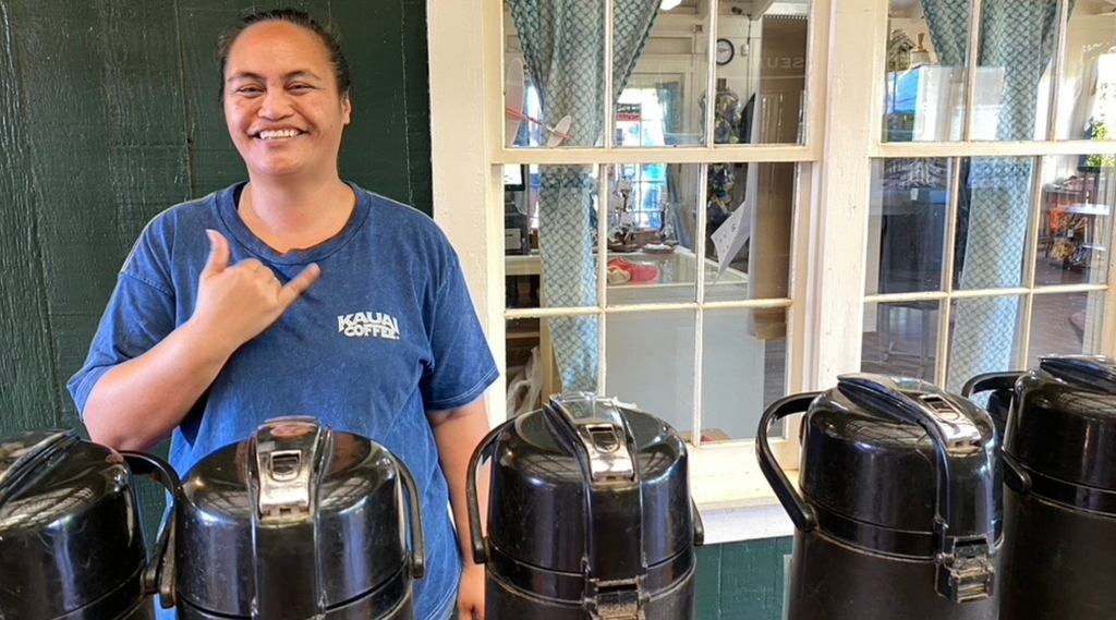 Kauai coffee employee shares a shaka and a smile