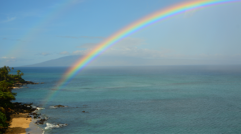 a rainbow over the view from maui to lanai