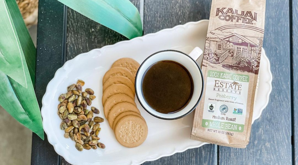 kauai coffee peaberry on a plate with cookies and nuts