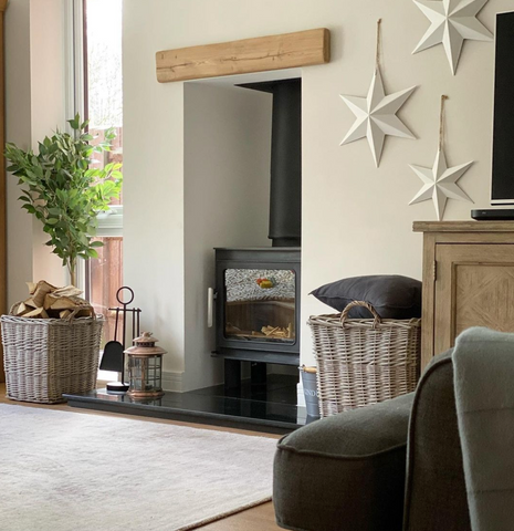 Two wicker log baskets positioned next to a log burner 