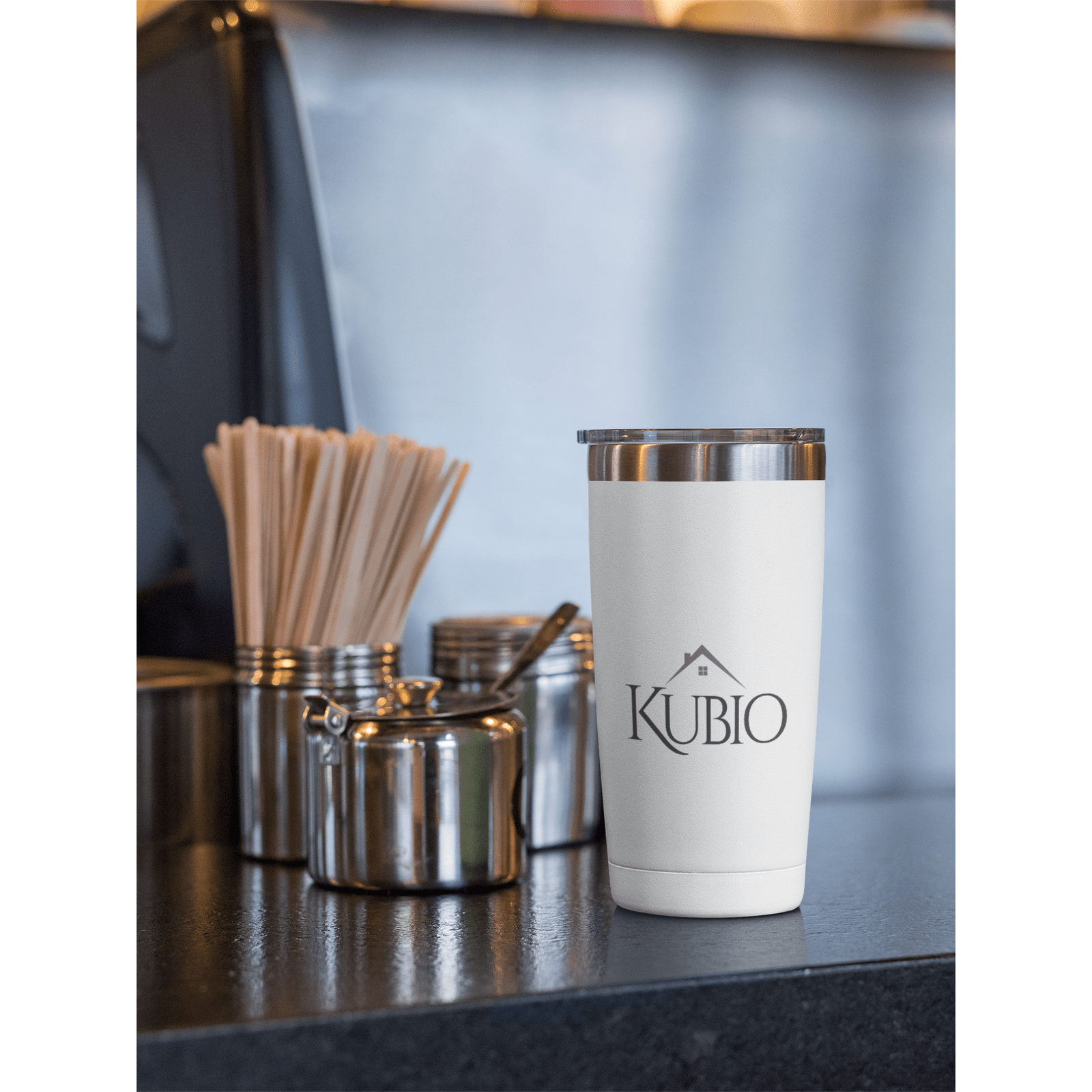 https://cdn.shopify.com/s/files/1/0629/1901/6663/products/20-oz-travel-mug-mockup-placed-by-stainless-steel-kitchen-containers-30390.png?v=1672268766