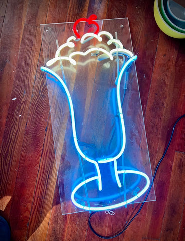 A real neon milkshake in blue, white, and red neon available at the Crockett neon sale
