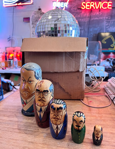 Vintage Russian President Nesting Dolls and an original disco ball with neon in the background