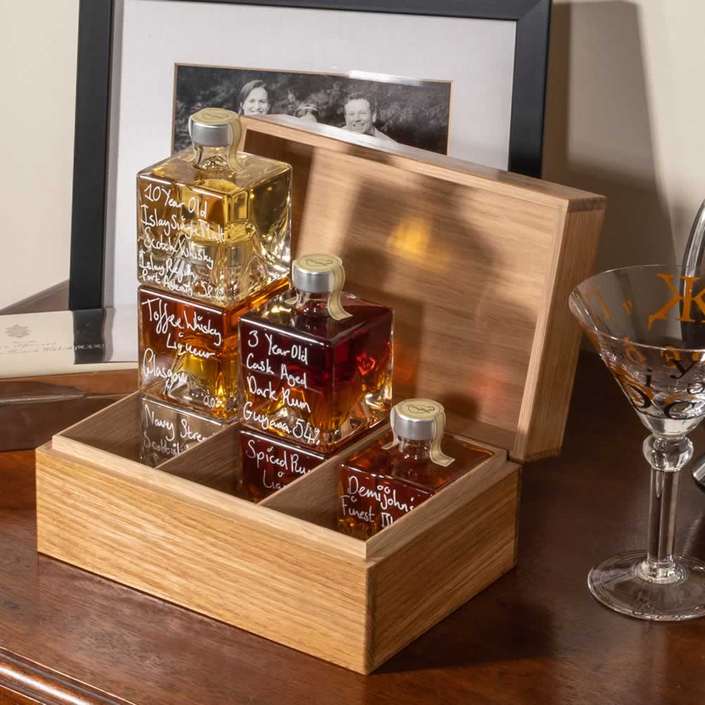 Hand crafted oak gift box with six cube glass bottles of whiskies and rums