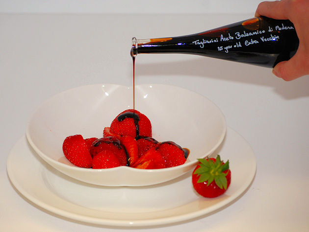 Pouring Balsamic Vinegar over Strawberries