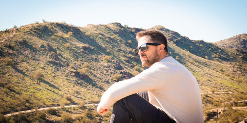 man in arizona desert mountains with sunglasses on