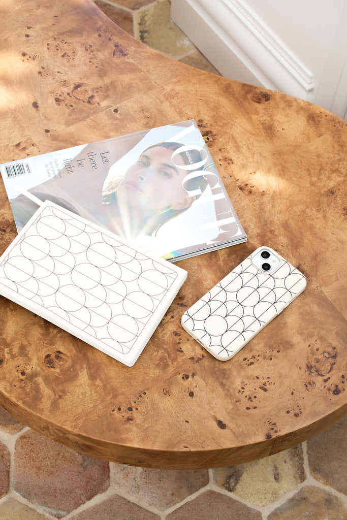 custom phone case on a desk with notebooks