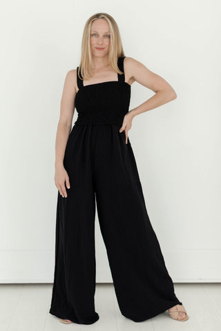 Our Sleeveless Smock Wide Leg Jumpsuit provides an oversized fit that adds a flattering shape, while the smocked bodice creates a comfortable fit. Thanks to its flowy style, the bottom fit is loose and long, but may need to be hemmed for those with shorter inseams. Alternatively, it can be worn with a longer hemline for a stylish, trendy look.
