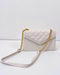 This Vegan Leather Quilted Envelope Purse adds a touch of elegance to any ensemble. The quilted detail provides a chic touch, while the gold chain strap ensures the purse looks modern and trend-right. Perfect for stashing all your necessities, it oozes sophistication.