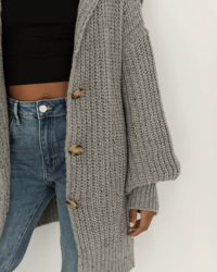 This gray oversized ribbed buttonfront cardigan is perfect for a cozy feel all day long. Its generous fit and roominess makes it ideal for cold days, allowing you to layer up in warmth. Also perfect for lounging in comfort.