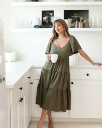 This midi dress is the perfect fall staple. Its olive color and flounce sleeve, tiering, and back cross tie make it the ideal fit for any occasion, whether casual or dressy.