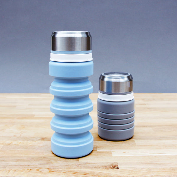 https://cdn.shopify.com/s/files/1/0629/6020/6071/products/gdw-rubber-water-bottles-both-blue-main_FLATLID_600x.jpg?v=1669907203