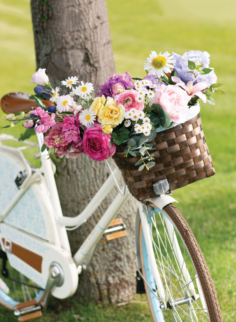Faux flowers in bicycle basket