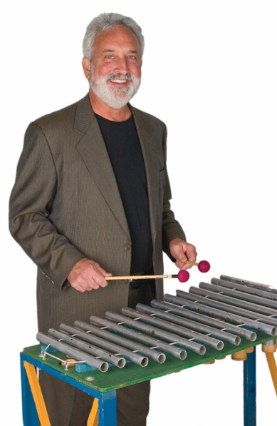 Garry Kvistad with the Adapted Lawn Chair, a metallophone he created to hear the scale of Olympos and the ancestor of all Woodstock Chimes.