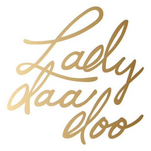 Image is of a logo that is gold and reads lady daa doo