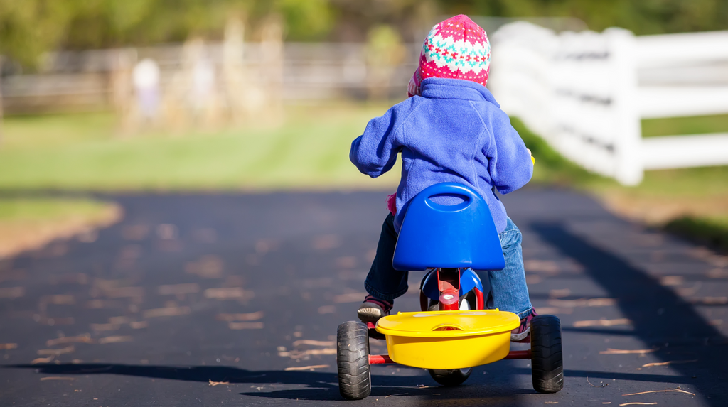 kid riding a tricycle