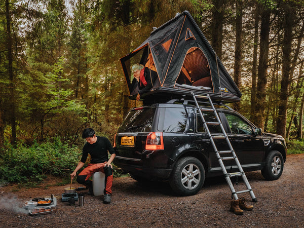 Cargo roof tent in woodland camping scene