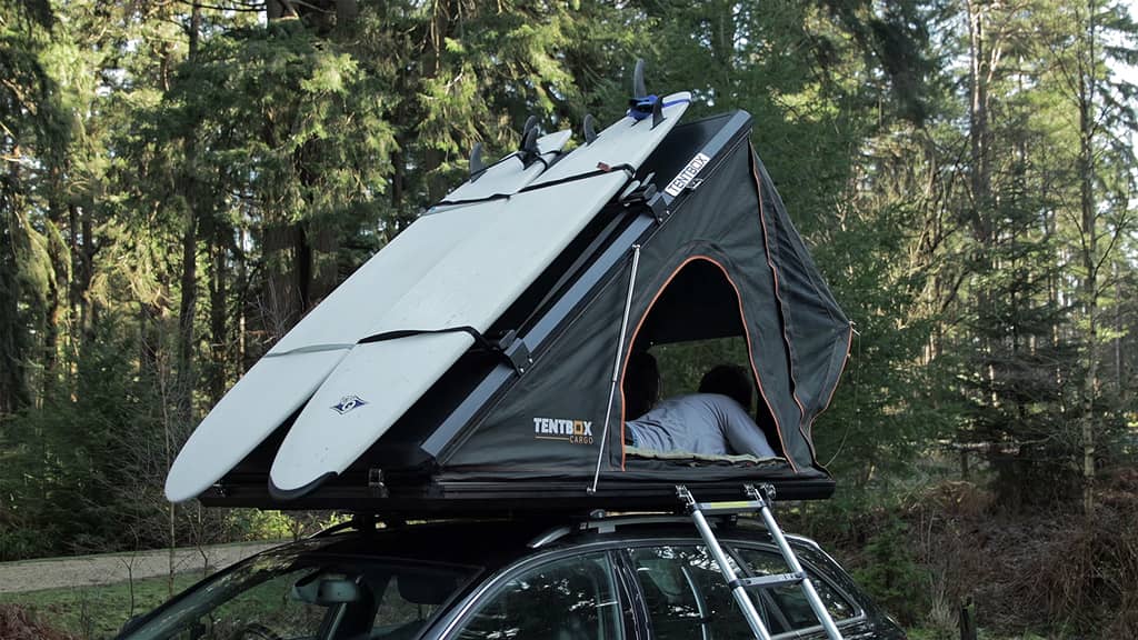 TentBox cargo in woodland with roof bars attached, carrying two surf bars