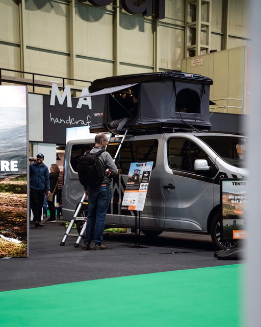 Man inspecting TentBox Classic roof tent at NEC camping show