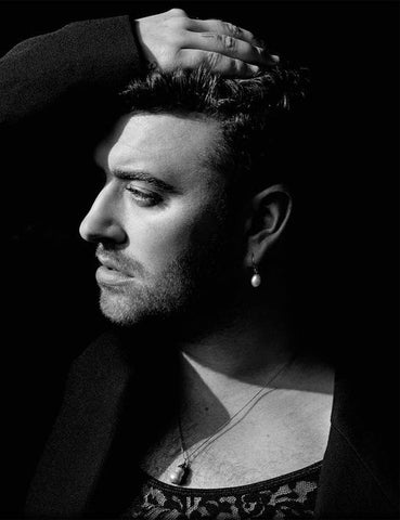 Sam Smith wearing pearl earrings and necklace