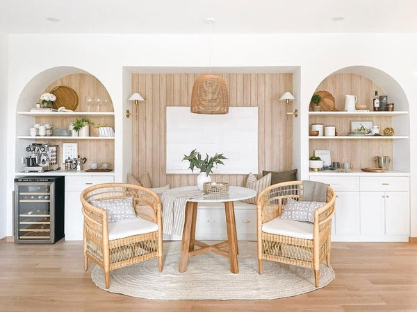 a set of rattan chairs brings a rustic and charming aesthetic to the space