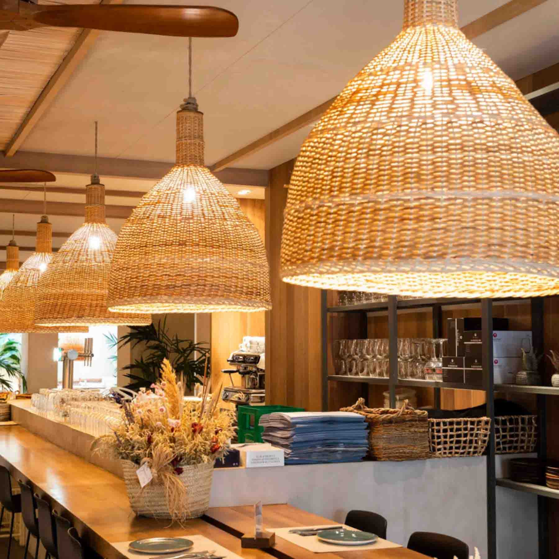 dining beneath the golden radiance of rattan pendant lights imparts a warm and inviting ambiance to customers