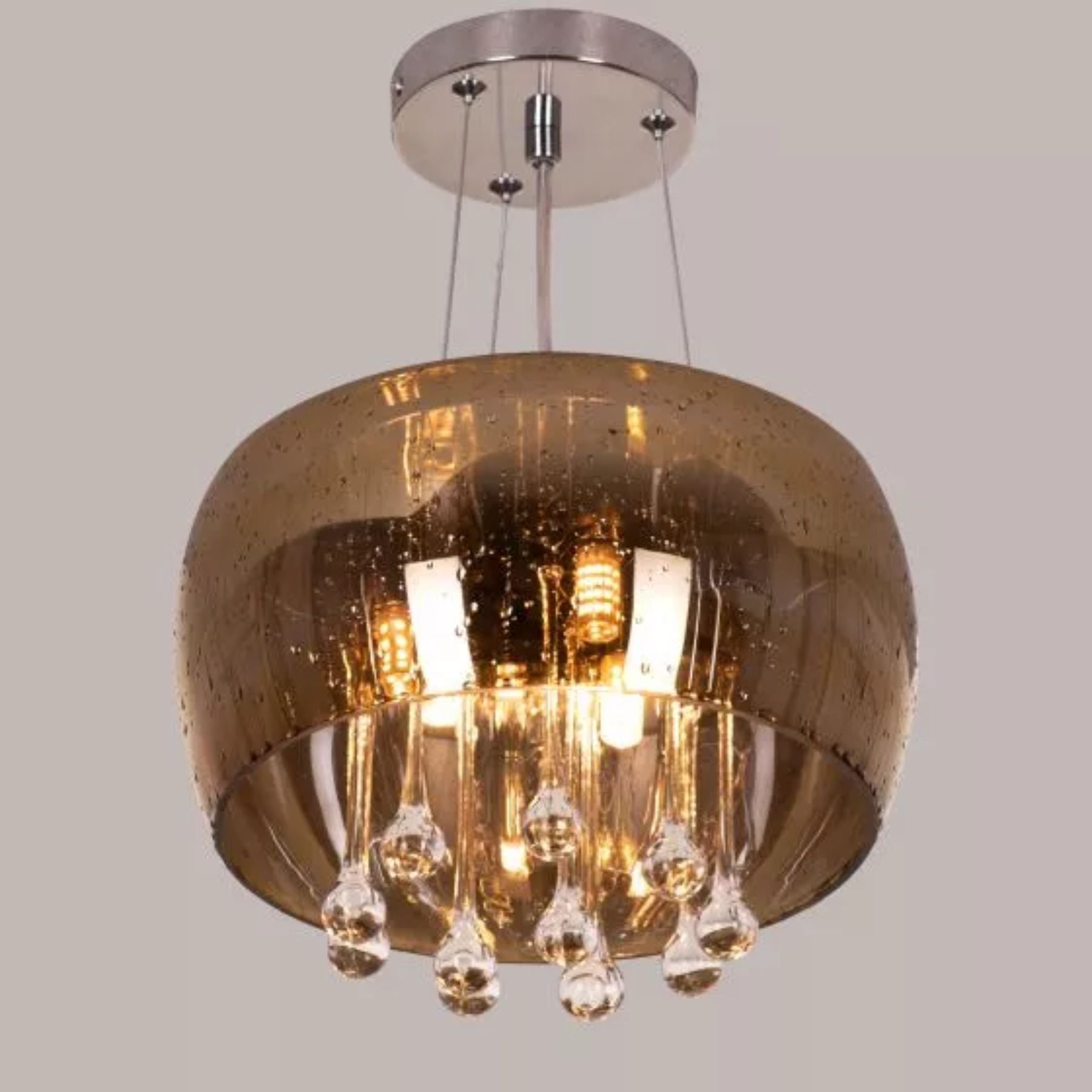 gold mirrored crystal pendant lights are hung elegantly reminiscent of sparkling drops of frozen water