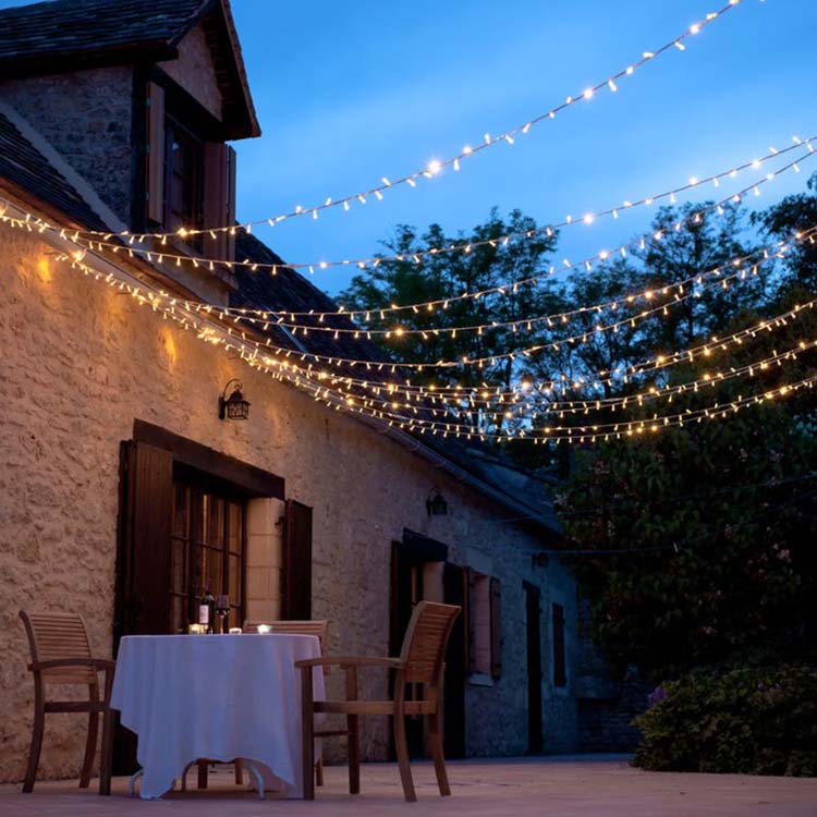 set up a romantic outdoor dinner with a small table and light canopy