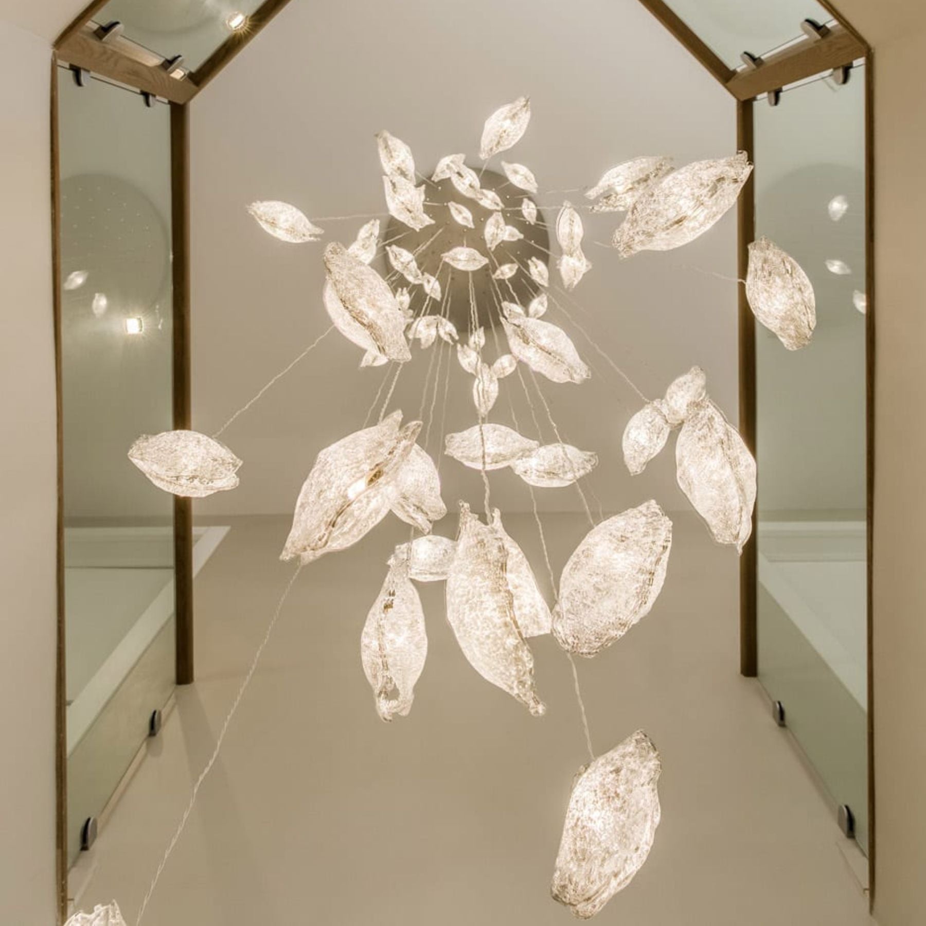 the crystal shell pendant lamp creates mesmerizing cracks in the glass disc and delicate ripples