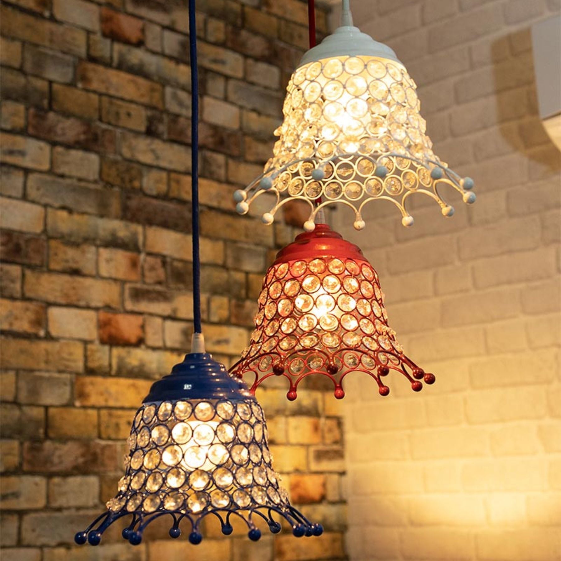 the crystal umbrella pendant features three hemispherical lamps with each lamp being half metal and half crystal