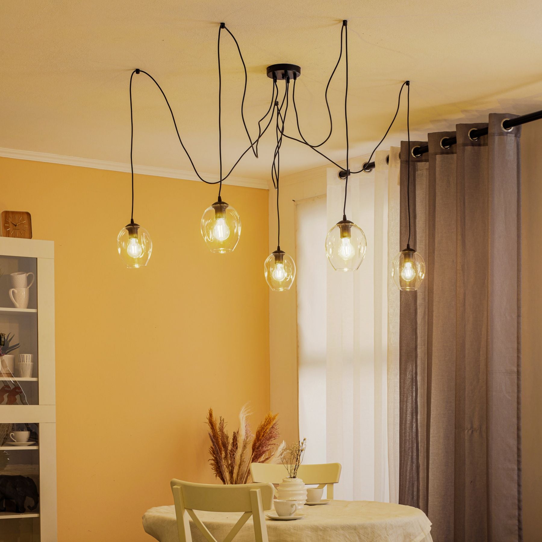 the technique of using hanging lamp clusters is especially effective in rooms with high ceilings or central accents