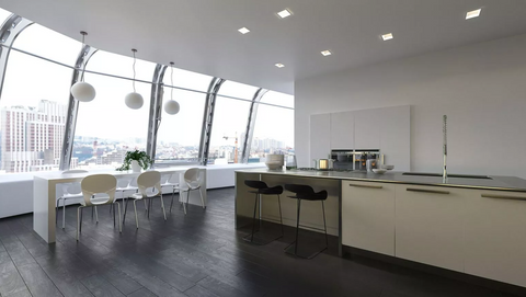 Spacious stainless steel kitchen with ample storage and natural light.