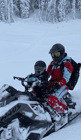 mom and child on snowmobile