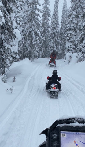 little boy on snowmobile