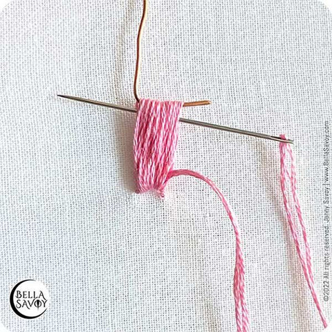 needle replacing hook inside loops of thread