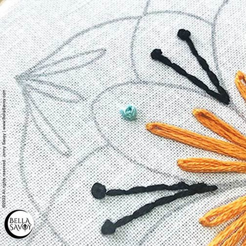 blue french knot above lazy daisy stitches