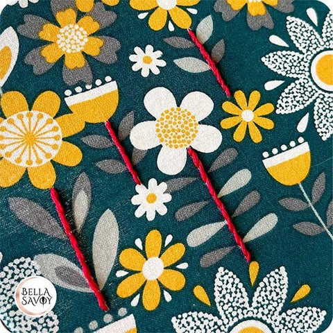 flower pattern fabric with stem and outline stitch added in red