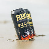BBQ Magazine beer cans dug into beach 