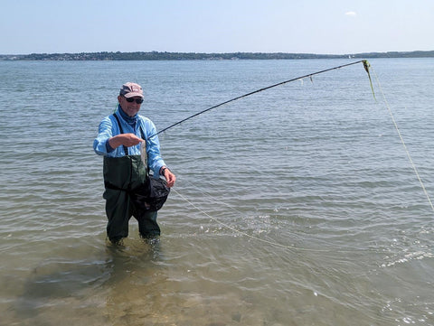 An angler fly fishing in the sea