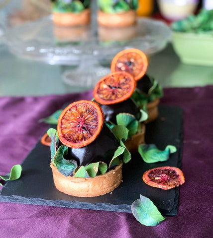 Image of individual desserts with dehydrated fruit decorations and edible sugar leaves.