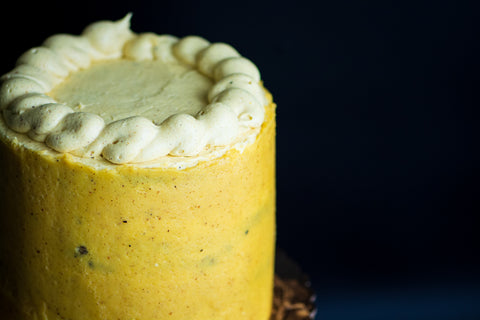 Close-up image of cake with yellow buttercream frosting.