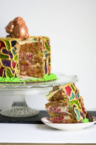 Slice of cake, decorated with handpainted mosaic collar, topped with edible chocolate bunny.