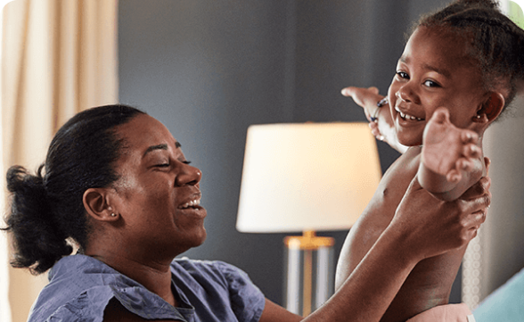 A mom playing with her happy toddler