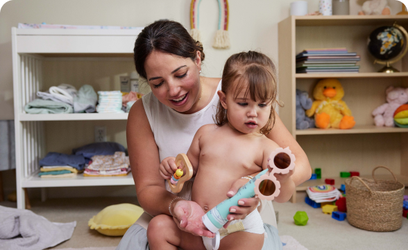 A woman applying Vivvi & Bloom’s 2-in-1 face and body whip lotion to her child