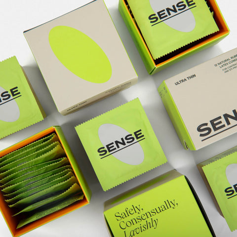 Aerial view of several boxes of sense ultra thin natural rubber latex condoms 12 pack