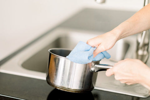 cleaning & drying stainless steel cookware with a soft towel