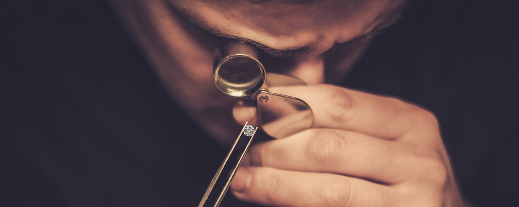 Jeweler using a loupe to check the quality of a diamond
